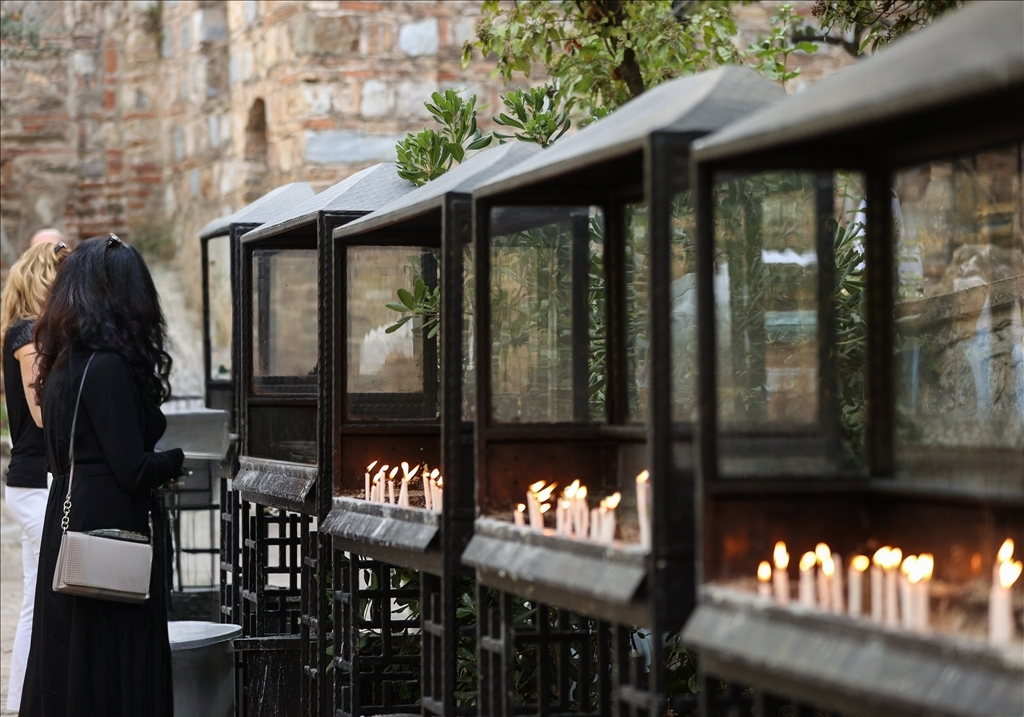 Visitors lighting candles and offering prayers at the House of Virgin Mary shrine in Selcuk, symbolizing faith and devotion.